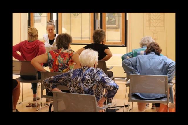 Participants in a seated yoga session at the Georgia Museum of Art